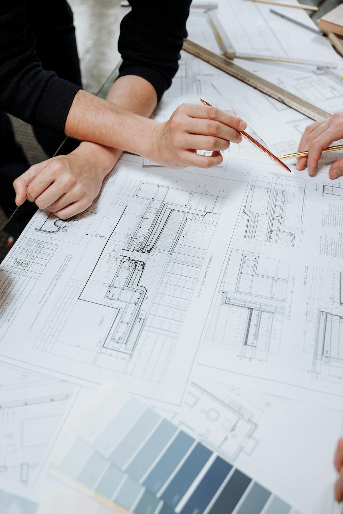 Architects collaborating over construction blueprints