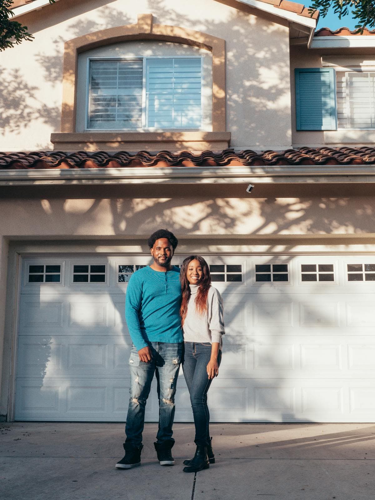 Happy homeowners in front of their Florida home