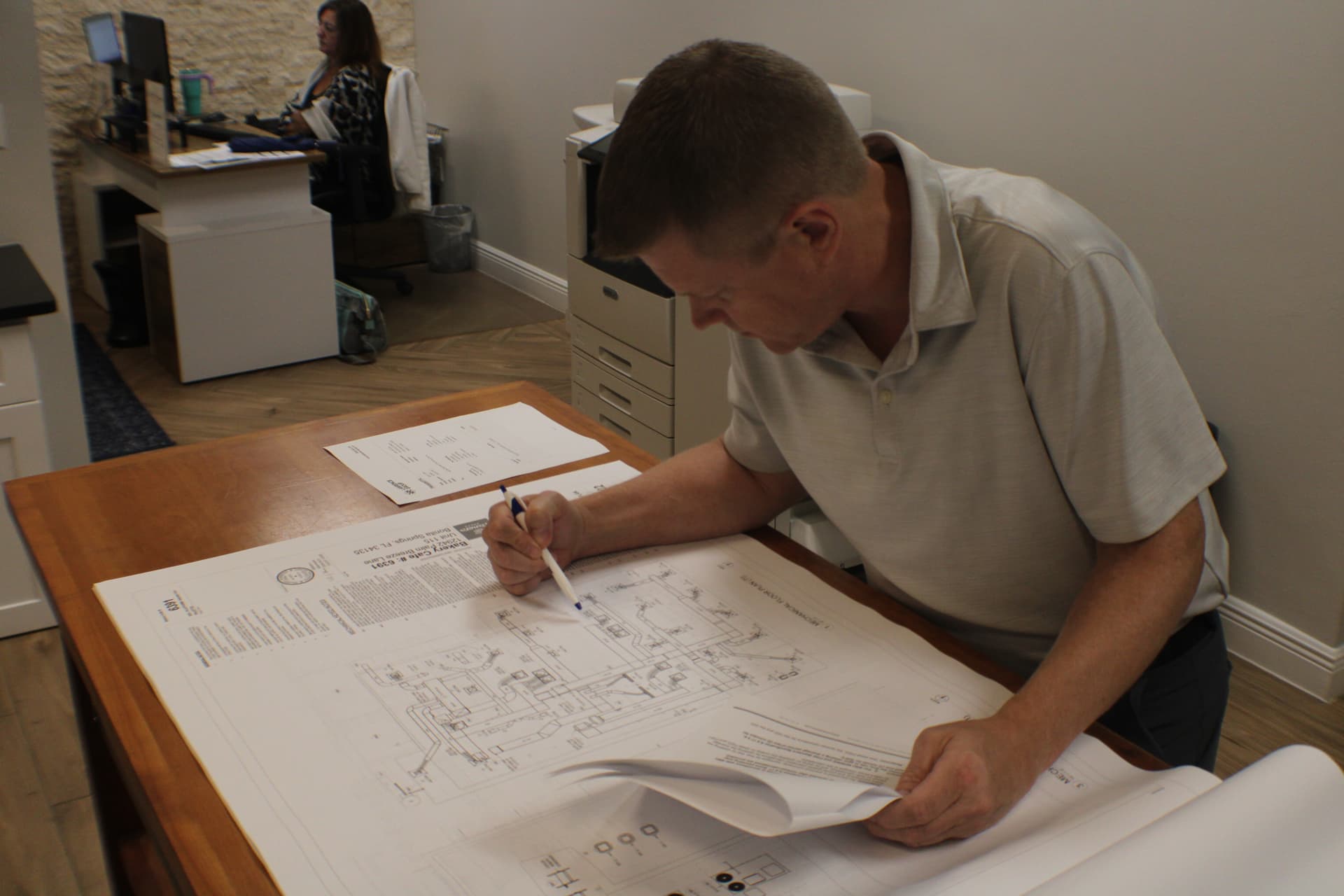 Elite Permits coordinator reviewing plans for a client project